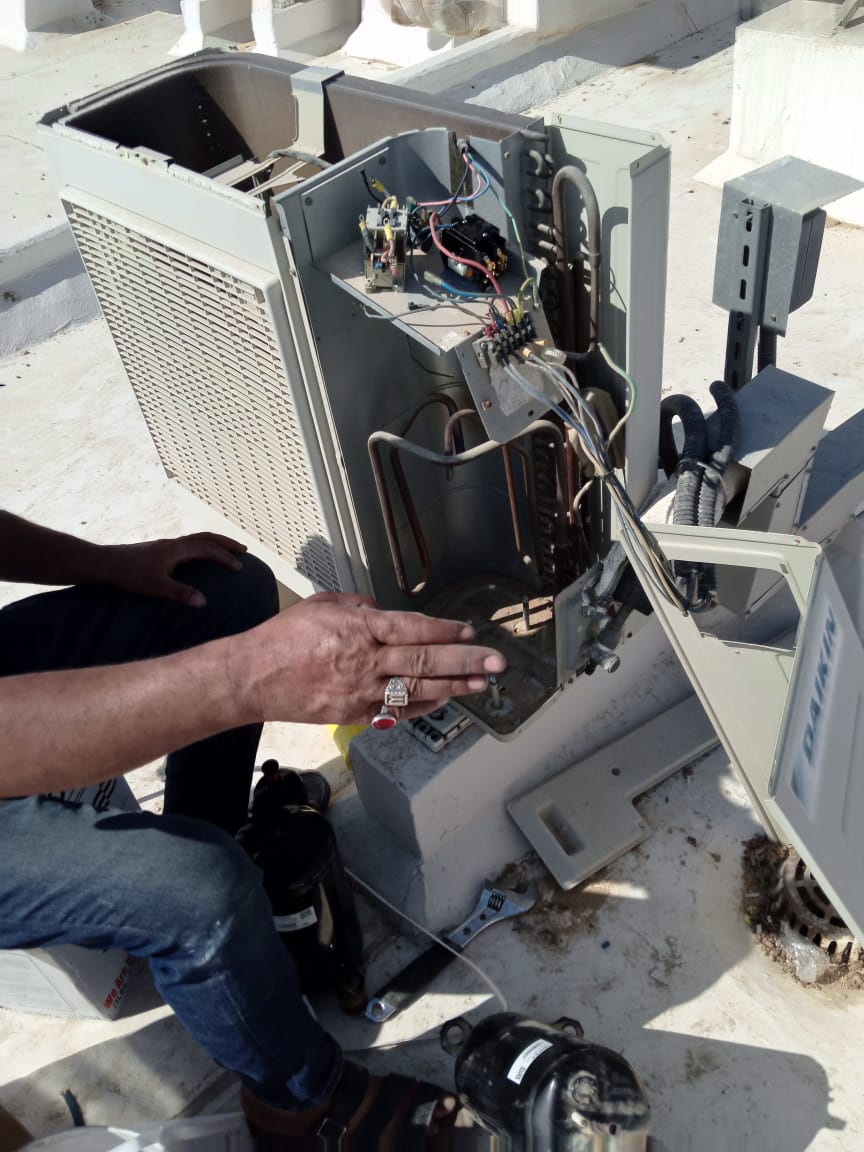 Technician working on AC unit